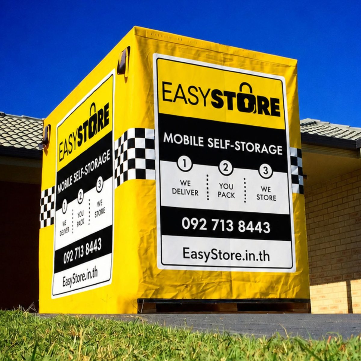 EasyStore mobile self storage box standing on a driveway outside a home